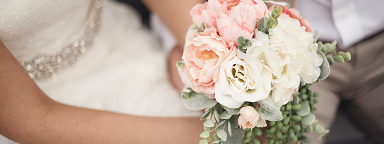 Bride holding white flower bouquet
