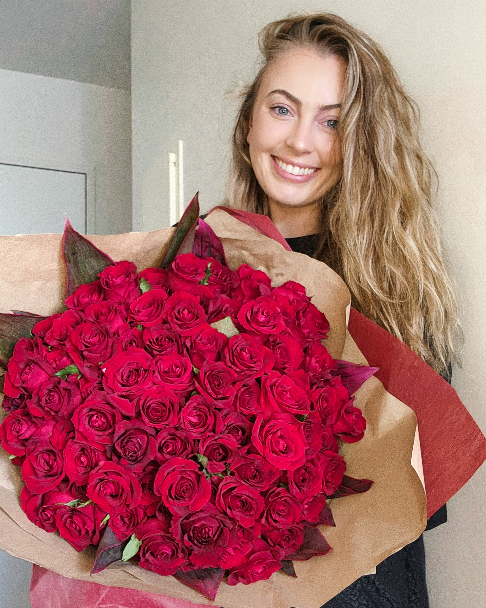 Big bunch of red roses with beautiful woman Valentine's Day gift